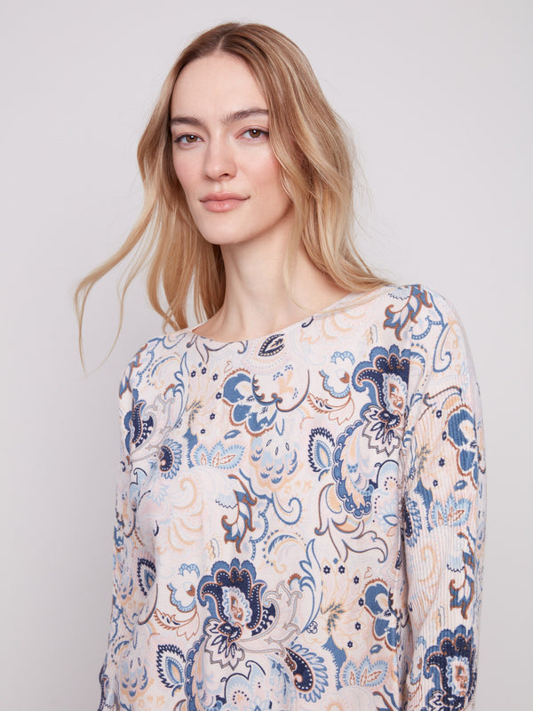 Stylish blush sweater with side pockets, adorned in an abstract floral print by Charlie B.
