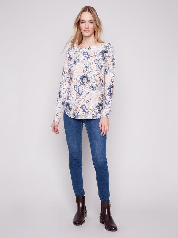 Sophisticated blush sweater highlighting side slits with intricate floral detailing for added elegance by Charlie B.