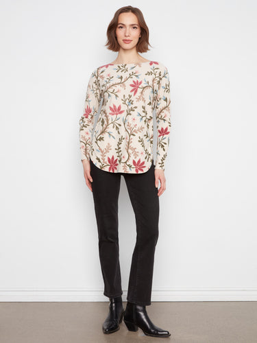 Chic floral print top with side pockets and a boat neckline, offering both style and functionality. By Charlie B.