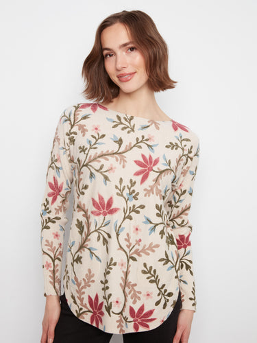 Stylish top with rounded hem and intricate floral motifs, creating an effortlessly elegant look. By Charlie B.