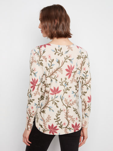 Beautifully crafted floral design on this top, highlighted by the unique boat neckline detail. By Charlie B.