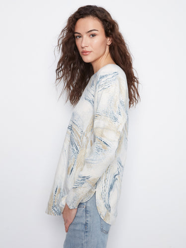 Comfortable knit with rounded hem and artistic print, great for layering in cooler weather by Charlie B.