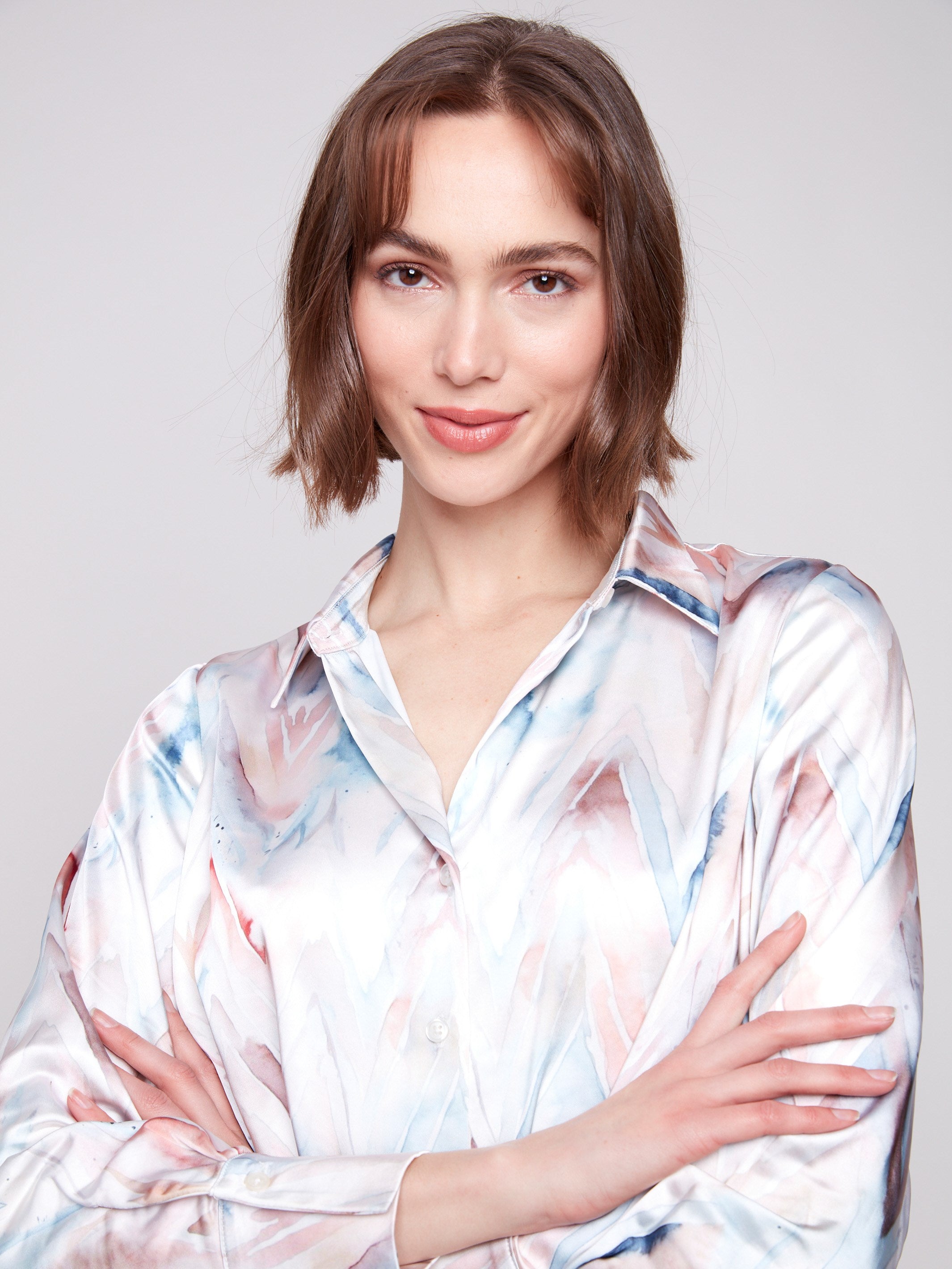 Chic satin shirt with long sleeves and unique twisted front detail for a refined look by Charlie B.