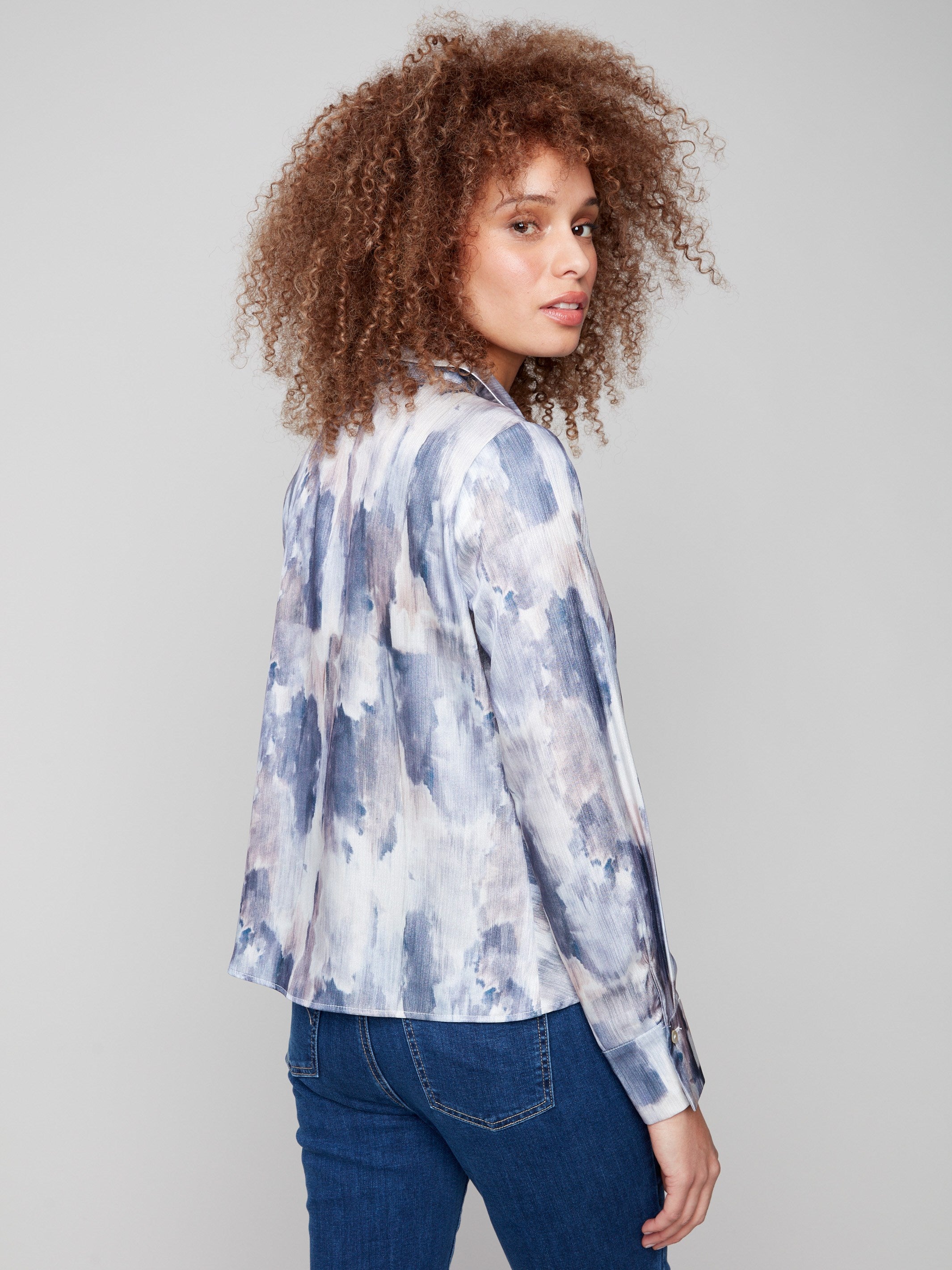 Long sleeves complement the abstract design of this chic button-down satin shirt by Charlie B.
