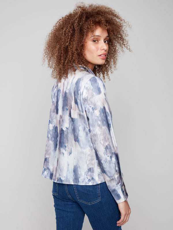 Long sleeves complement the abstract design of this chic button-down satin shirt by Charlie B.
