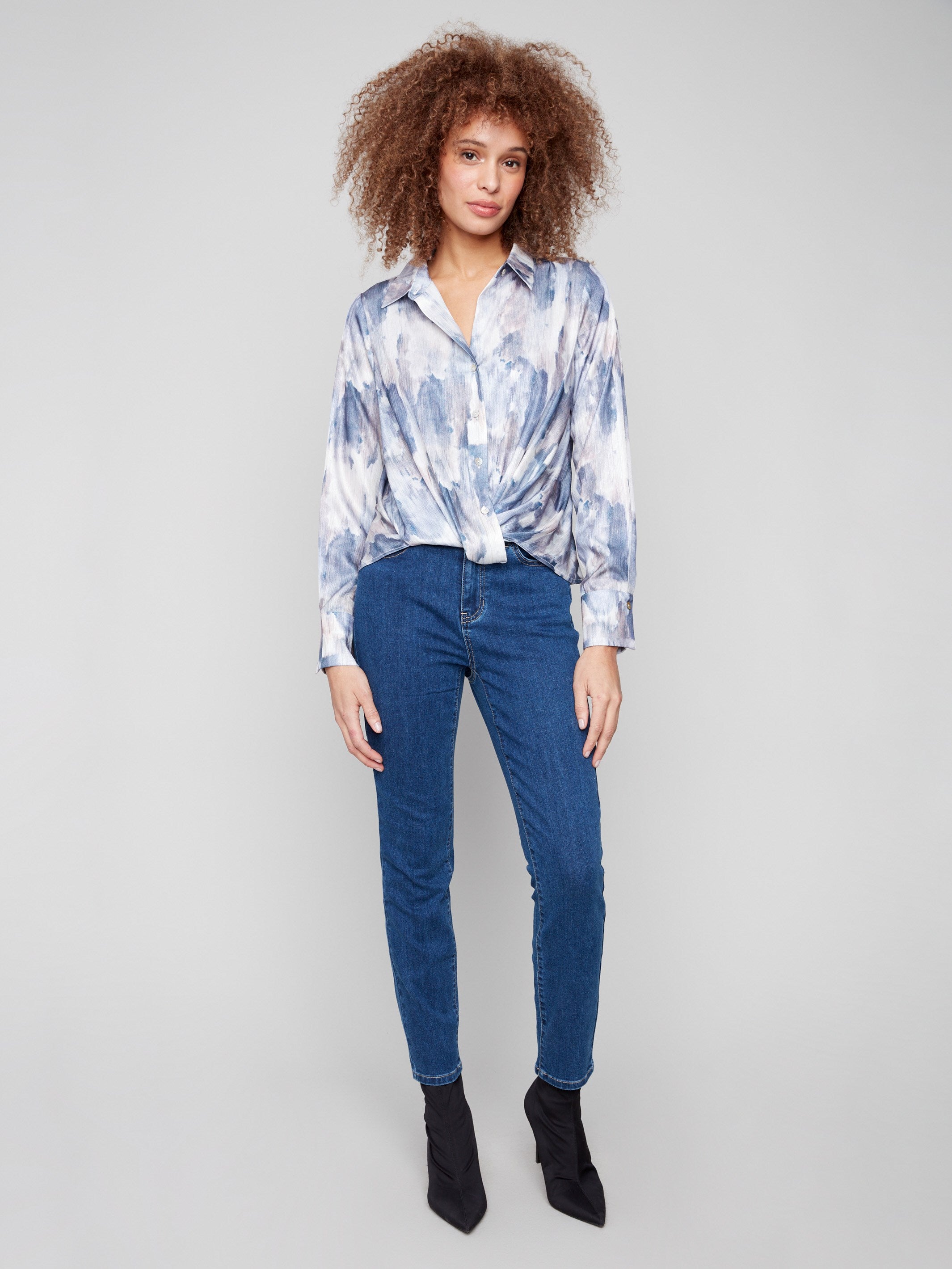 Twisted front detail enhances the contemporary look of this pearly button-down satin shirt by Charlie B.