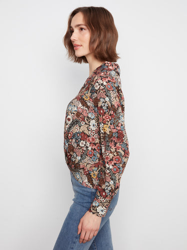 The blouse features a button-front closure, combining functionality with fashionable floral prints by Charlie B.
