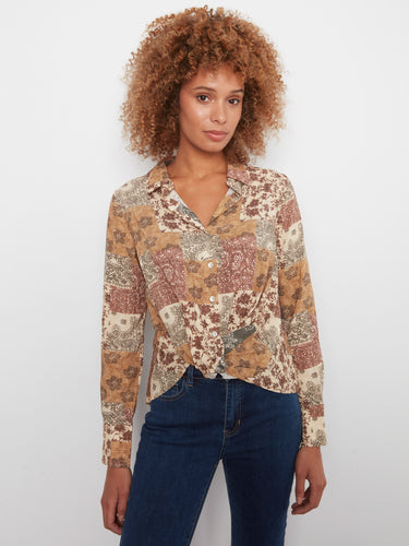 This patchwork shirt features a unique twisted front detail, adding flair to any outfit you choose by Charlie B.