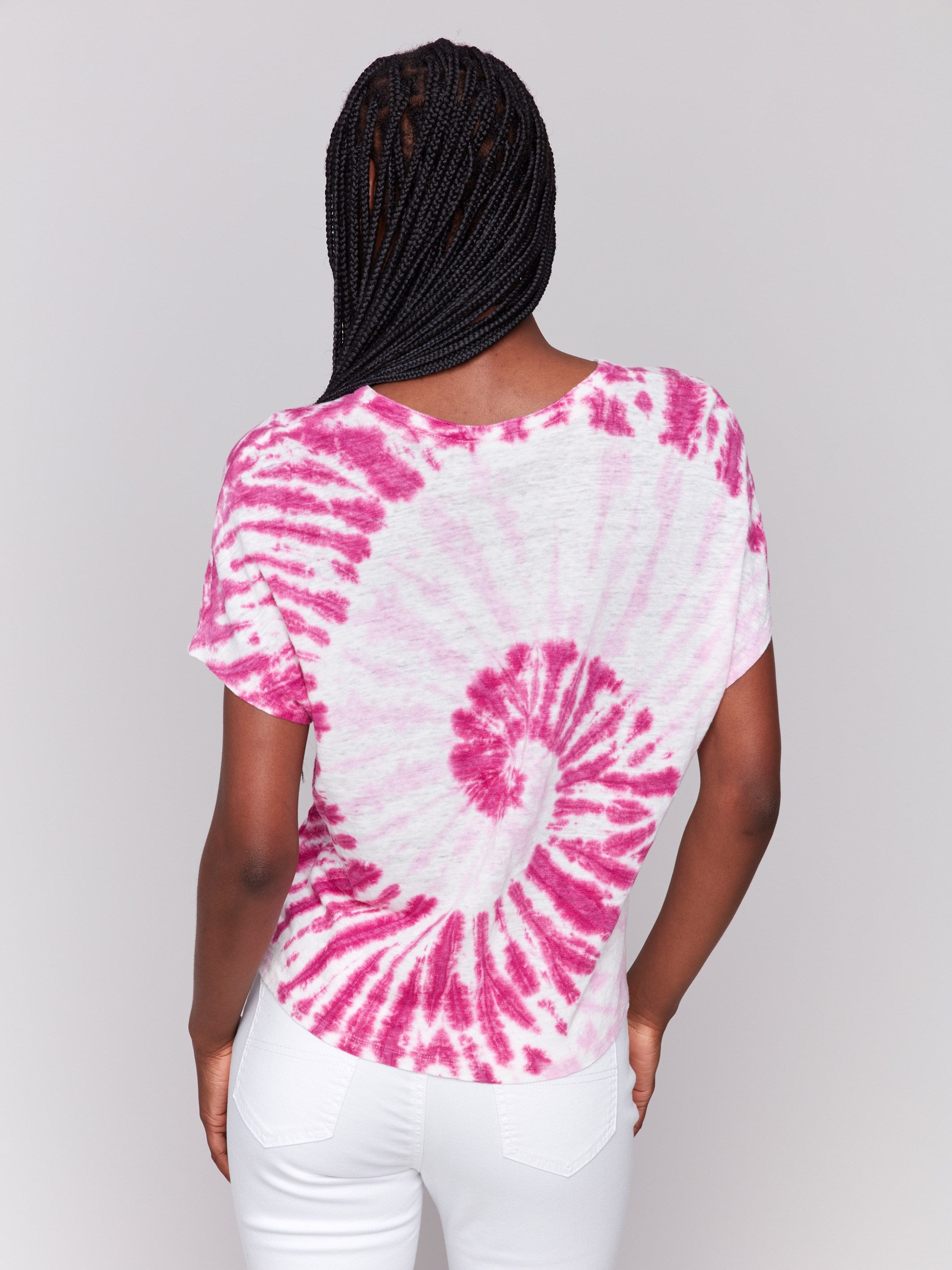 Relaxed fit pink dolman featuring a vibrant tie-dye design by Charlie B.