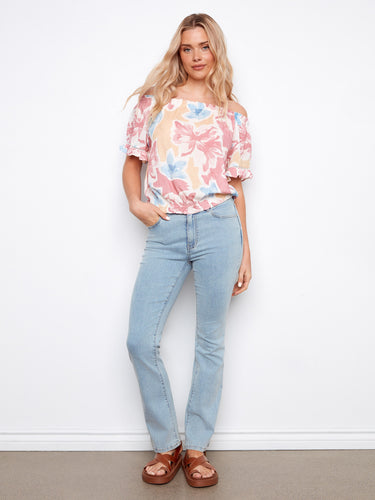 Elastic hem ensures comfort and style in this floral-patterned blouse by Charlie B.