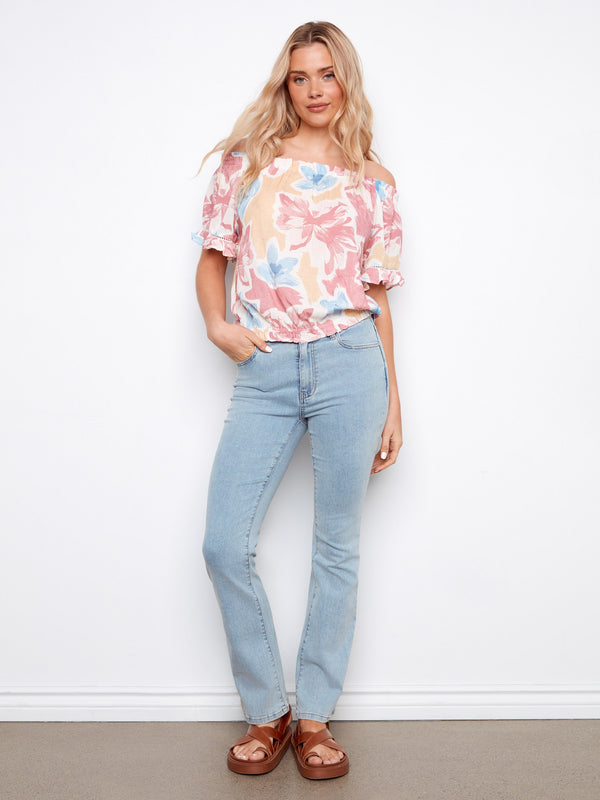 Elastic hem ensures comfort and style in this floral-patterned blouse by Charlie B.