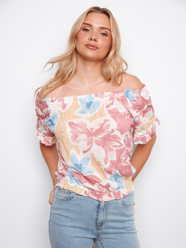 Off-the-shoulder floral blouse with delicate flutter sleeves for an elegant appearance by Charlie B.