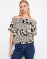 This top features an off-the-shoulder design, showcasing a stylish and relaxed fit, perfect for any casual outing by Charlie B.