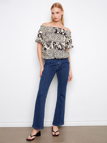 The short flutter sleeves add a playful touch to this elegant top, making it a versatile piece for your wardrobe by Charlie B.