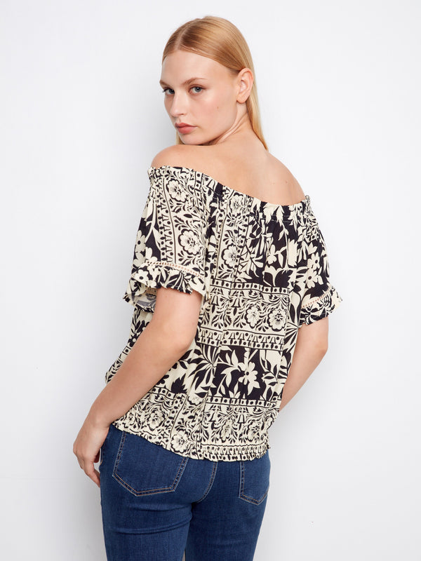 The intricate pattern on this off-the-shoulder top complements the short flutter sleeves beautifully by Charlie B.