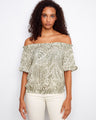 A stylish top featuring an off-the-shoulder design with a unique pattern, perfect for a chic look. By Charlie B.