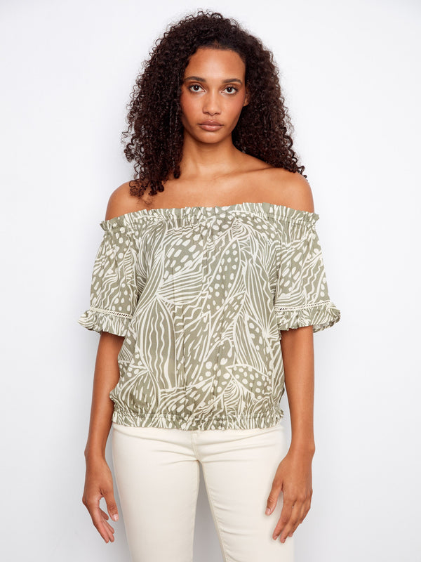 A stylish top featuring an off-the-shoulder design with a unique pattern, perfect for a chic look. By Charlie B.