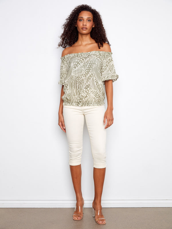 This elegant blouse has short flutter sleeves that add a touch of femininity to any outfit. By Charlie B.