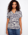 Floral-patterned top with a V neckline and short dolman sleeves, perfect for casual outings. Made from a lightweight linen blend by Charlie B.