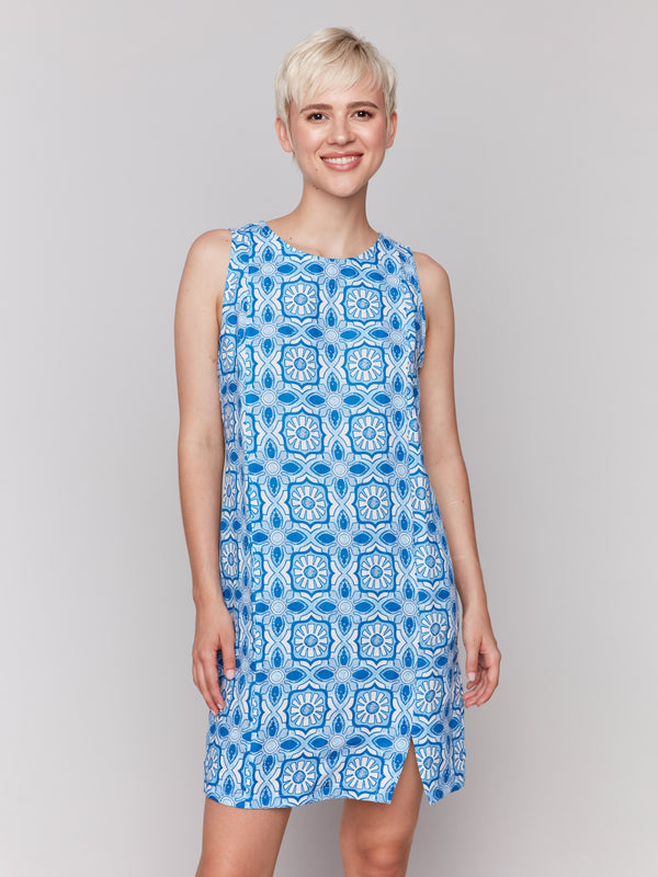 Knee-length dress featuring a sleeveless design and stylish front slit by Charlie B.