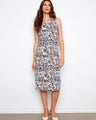 Elegant dress with a scoop neckline and intricate patterns, perfect for summer outings. Designed by Charlie B.