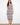 Elegant dress with a scoop neckline and intricate patterns, perfect for summer outings. Designed by Charlie B.