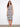 Elegant dress with a scoop neckline and intricate patterns, perfect for summer outings. Designed by Charlie B.