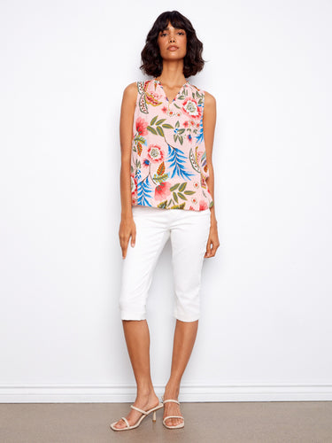 This sleeveless top features a ruffled neckline with colorful floral prints, ideal for warm weather styling by Charlie B.