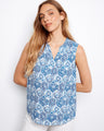 This stylish top features a V-neck design, adding an elegant touch to its intricate blue and white pattern. By Charlie B.