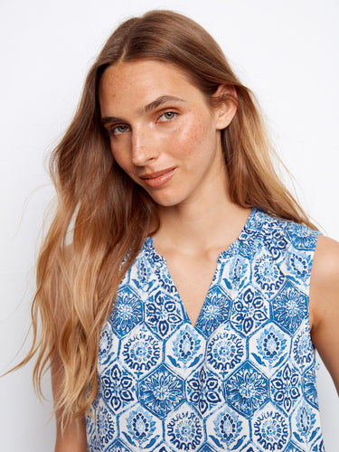 The sleeveless design of this top offers comfort and style, perfect for warm days with its vibrant pattern. By Charlie B.