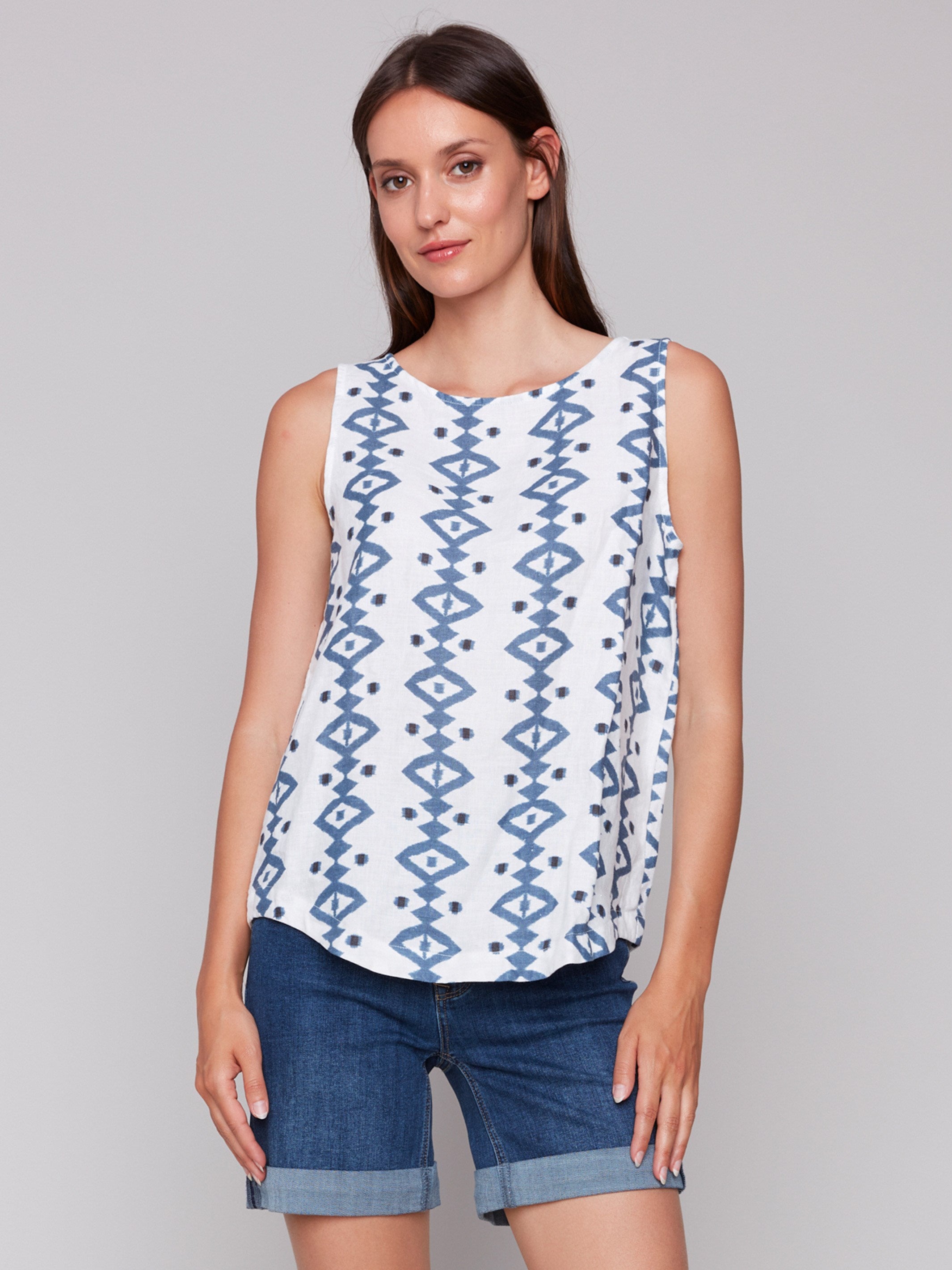 Geometric pattern sleeveless top with a rounded hem by Charlie B.