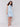 Elegant sleeveless design with knee-length tiered skirt by Charlie B.