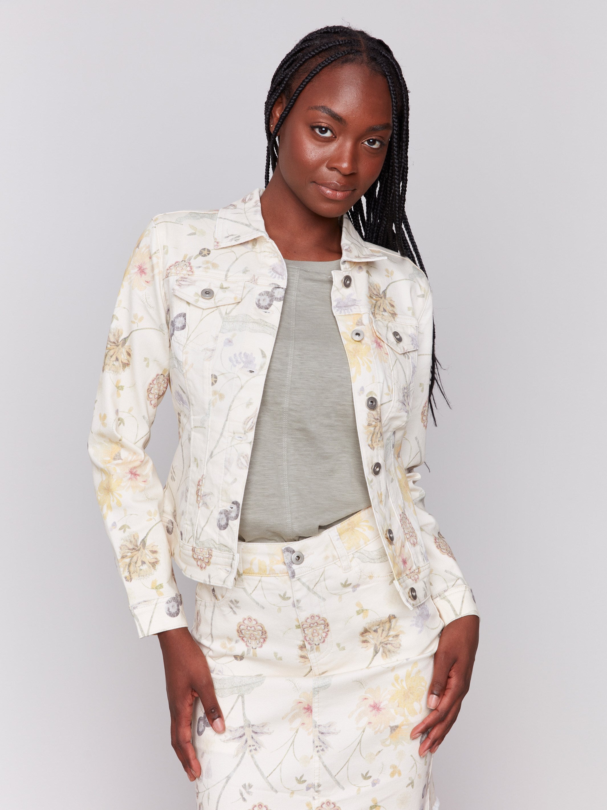 Denim jacket with a spread collar and floral garden print by Charlie B.