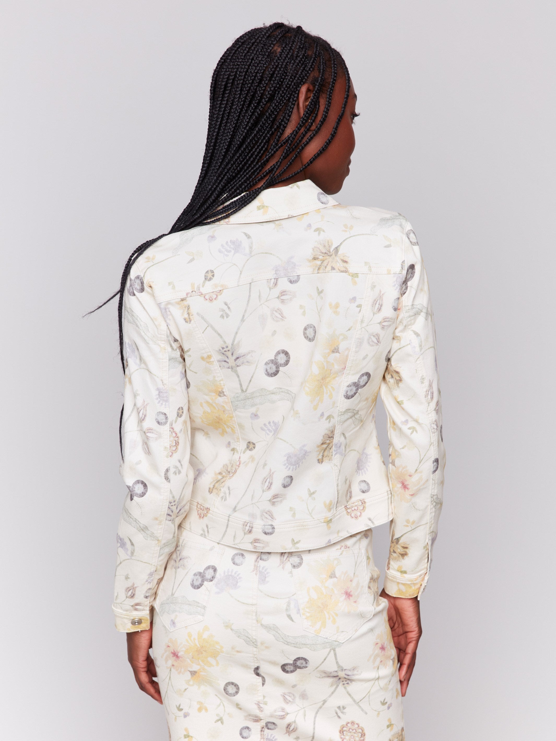 Stylish denim jacket showcasing an intricate floral print by Charlie B.