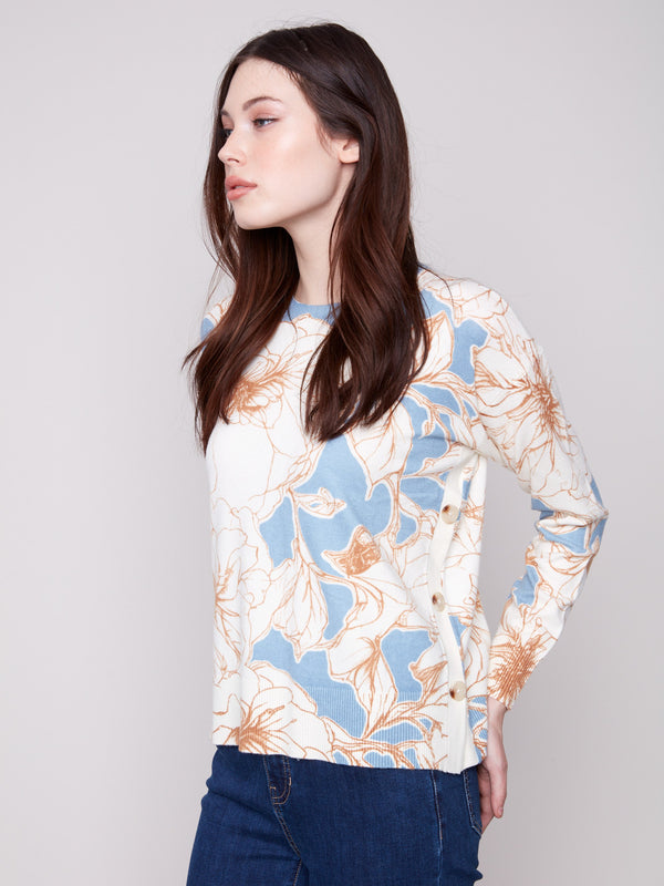 Elegant sweater adorned with side buttons, showcasing a beautiful floral mist design by Charlie B.