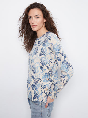 Elegant floral top with side buttons adding a touch of charm to your everyday look. Designed by Charlie B.