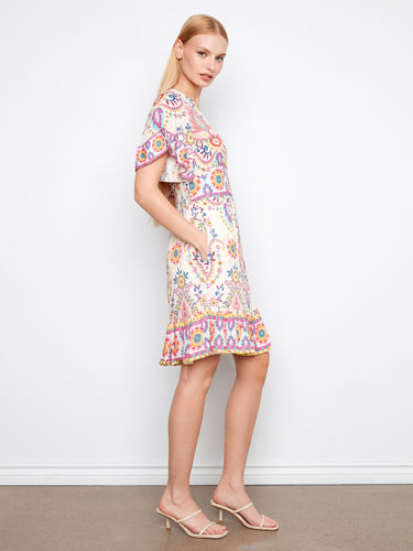 Colorful dress featuring a smocked back waist and elegant flutter sleeves with vivid designs by Charlie B.