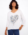 Elegant white top with heart-shaped floral design, featuring a placement print and 3/4 sleeves by Charlie B.
