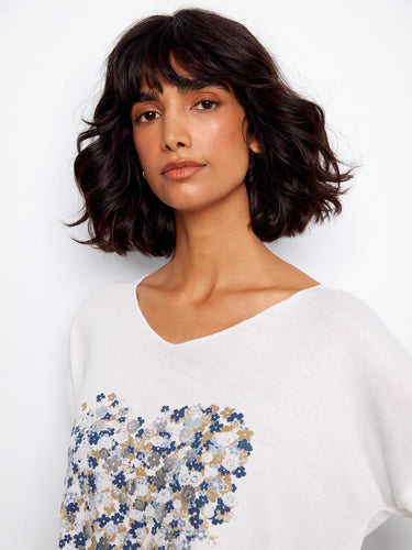Sophisticated V-neck blouse adorned with an intricate floral placement print in blue and white hues by Charlie B.