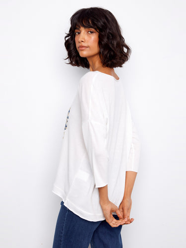 Trendy white top highlighting a lovely heart-shaped floral motif, complete with comfortable 3/4 sleeves by Charlie B.