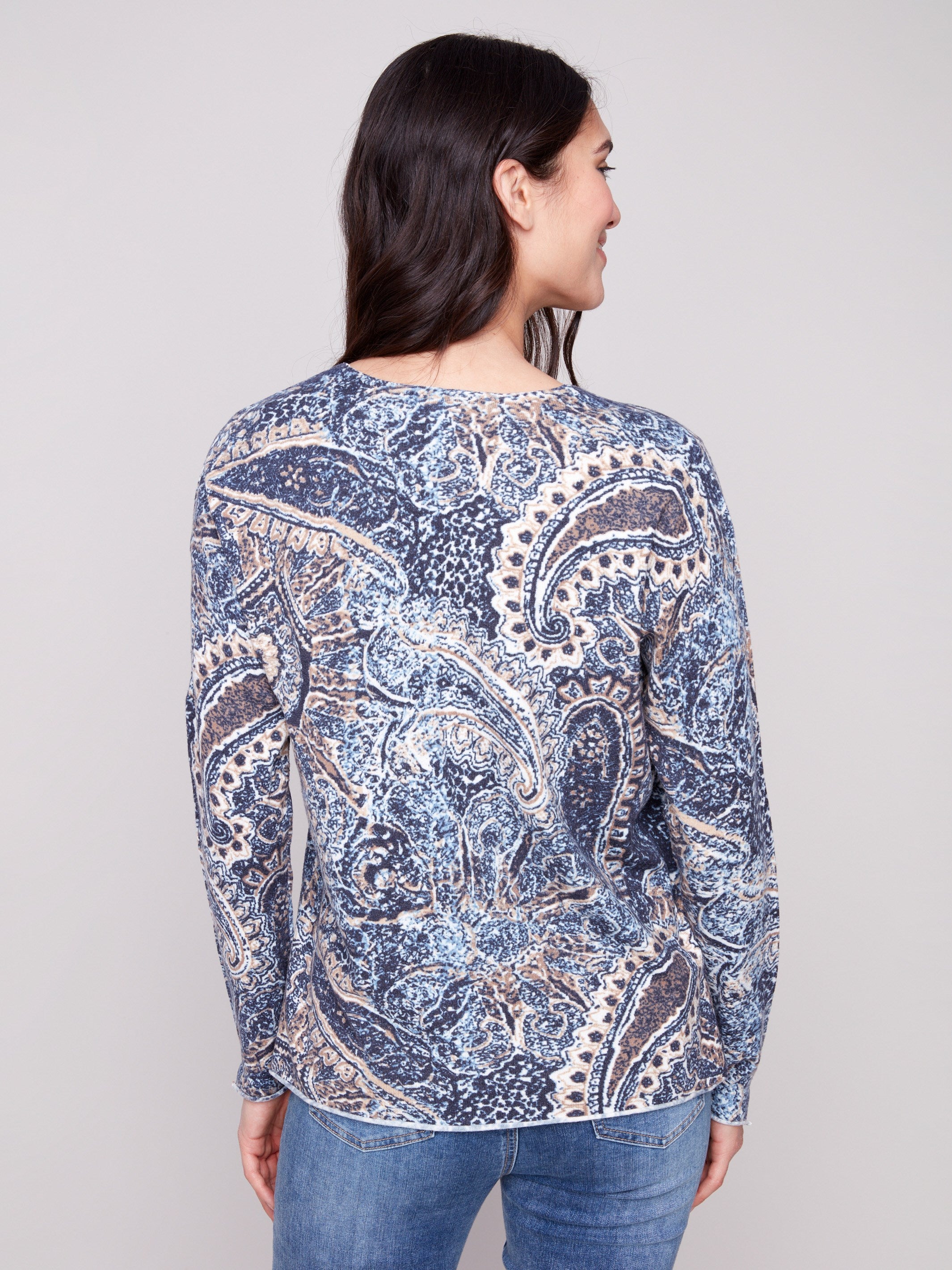 Sweater with a plushy yarn texture and colorful paisley pattern, detailed with side slits at cuffs and hem for added flair by Charlie B.