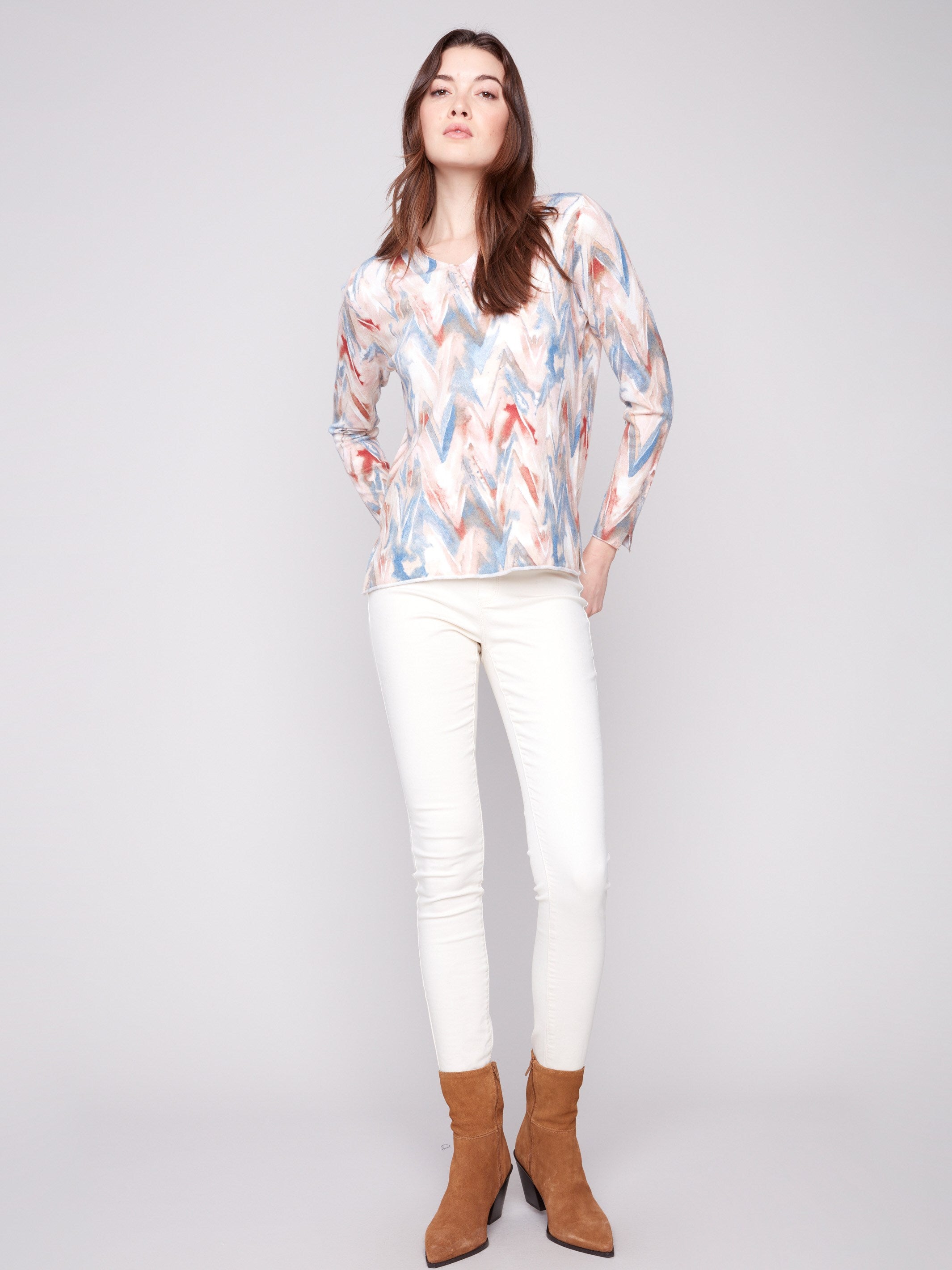 Colorful chevron patterned sweater featuring side slits at cuffs and hem for a modern twist by Charlie B.