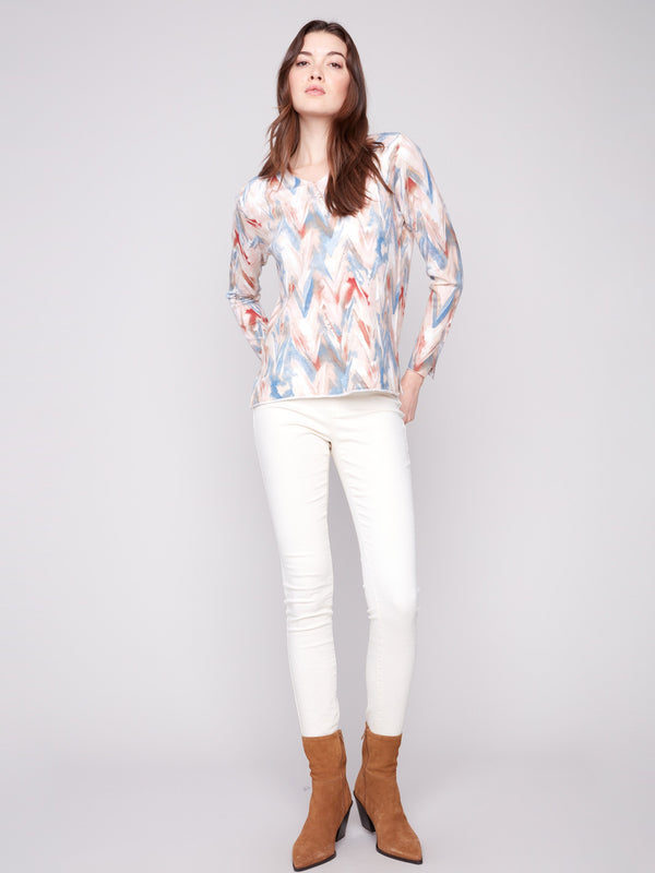 Colorful chevron patterned sweater featuring side slits at cuffs and hem for a modern twist by Charlie B.