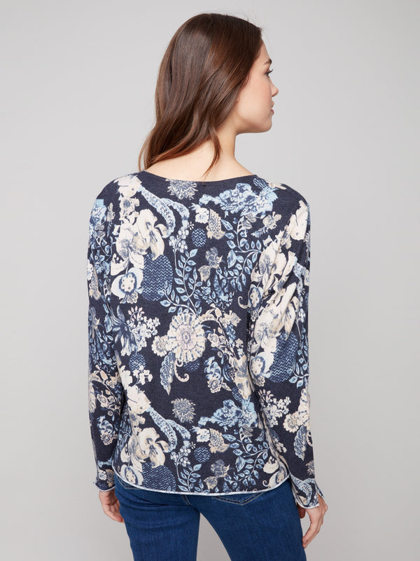 Sweater with a plushy yarn texture and colorful floral pattern, designed with side slits at cuffs and hem by Charlie B.