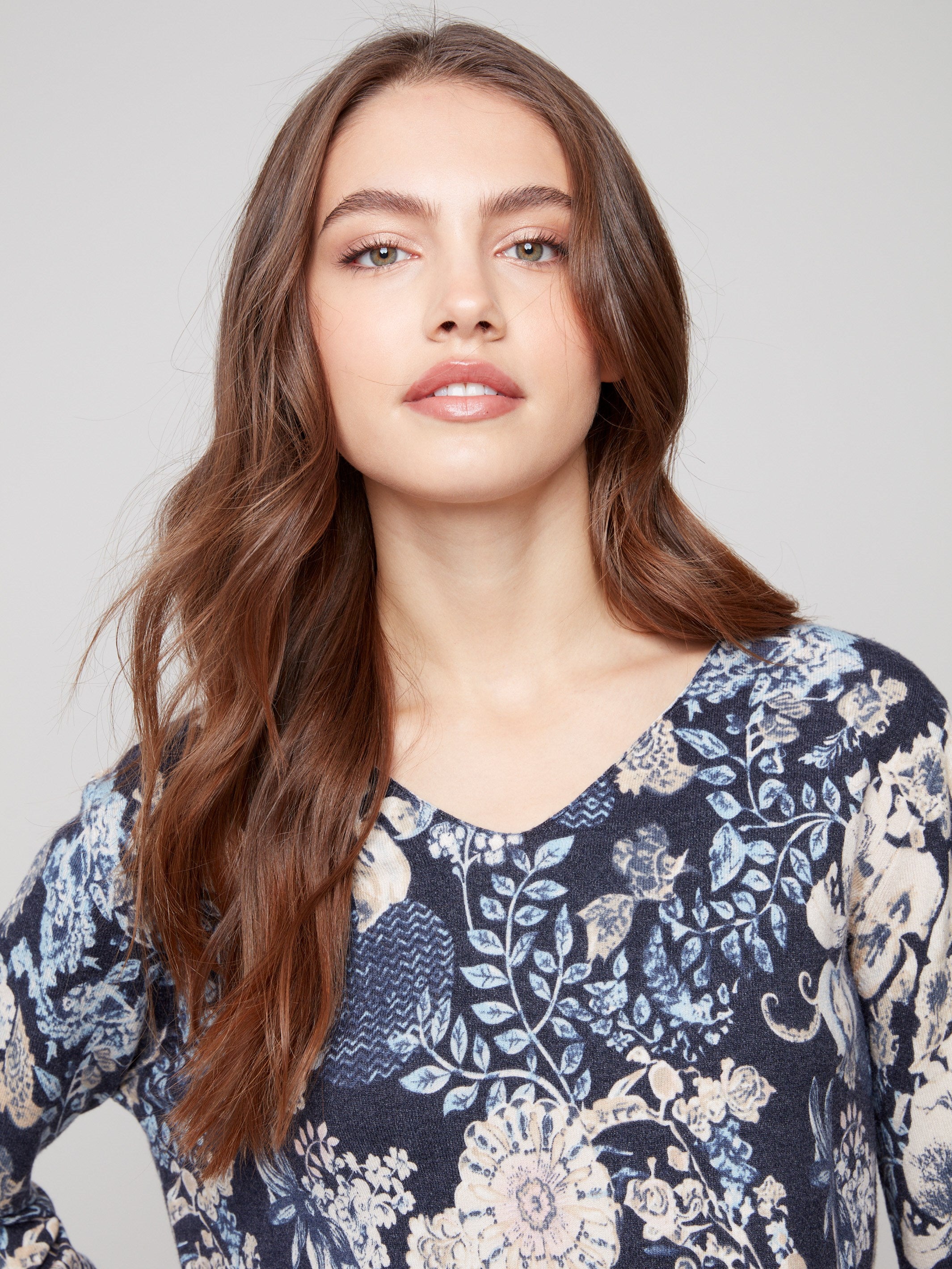 Sweater with a plushy yarn texture and colorful floral pattern, crafted to highlight its elegant V-neckline by Charlie B.