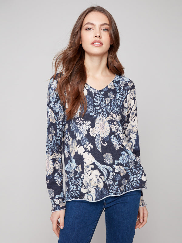Sweater with a plushy yarn texture and colorful floral pattern, offering long sleeves for cozy wear on cool days by Charlie B.