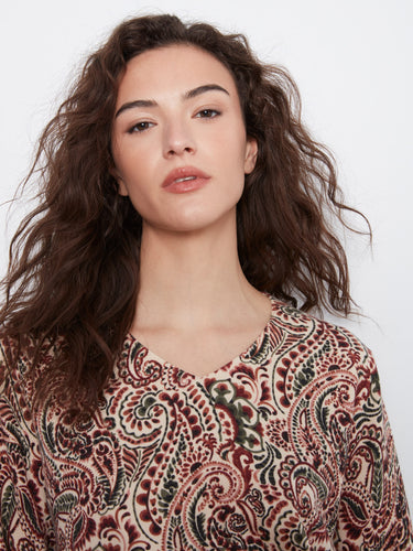 The side slits at the cuffs and hem offer a modern twist to this classic patterned top, enhancing its overall appeal. By Charlie B.