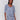 Blue top with geometric pattern and V-neck design by Charlie B.