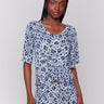 Blue top with geometric pattern and V-neck design by Charlie B.