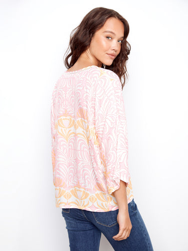 Delicate ladder stitch detail enhances this elegant V-neck top's charm, making it a versatile wardrobe staple by Charlie B.